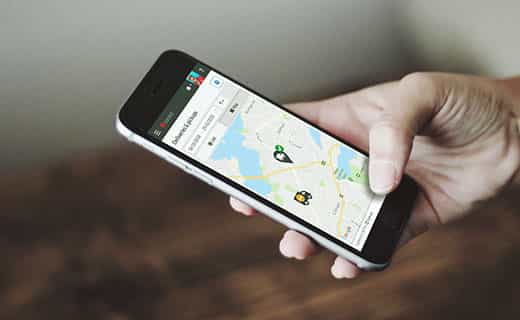 Hand holding a smartphone displaying a delivery tracking map